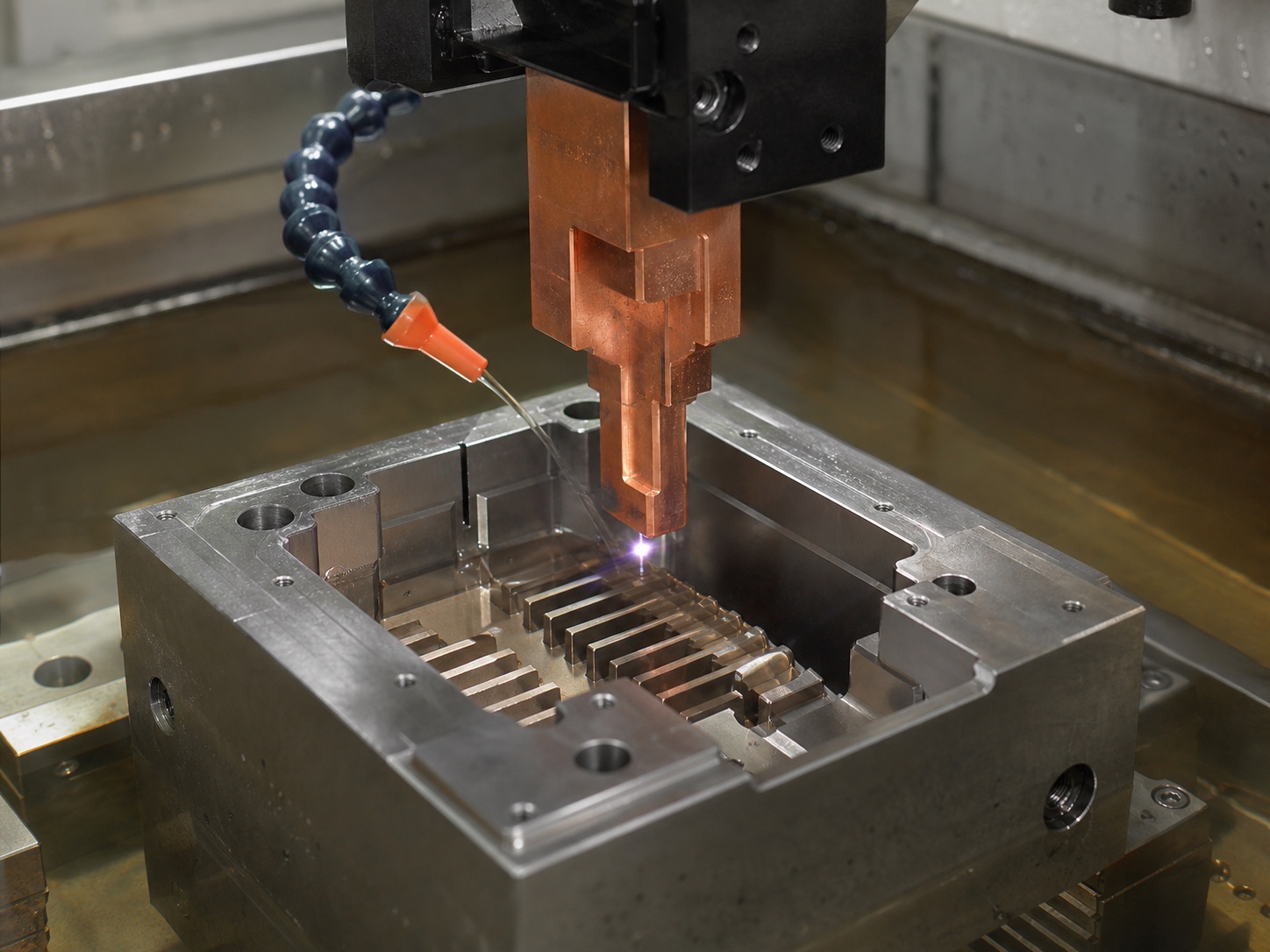 Copper die-sinking EDM electrode forming a cavity in a steel mold block